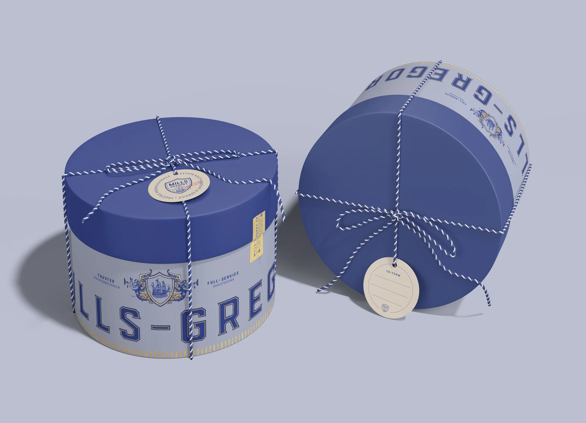 Blue, gold and tan Mills-Gregory round lot box with tag and blue and white striped twine.