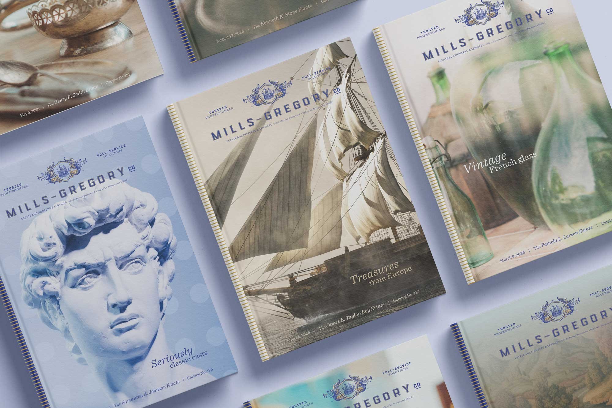 Mills-Gregory auction catalogs with cover photos including a sailing ship, statue of Michelangelo’s David and French glass.