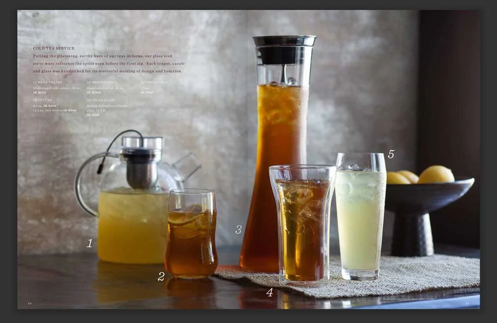 Cold tea service spread with chilled tea in tall carafe and glasses.