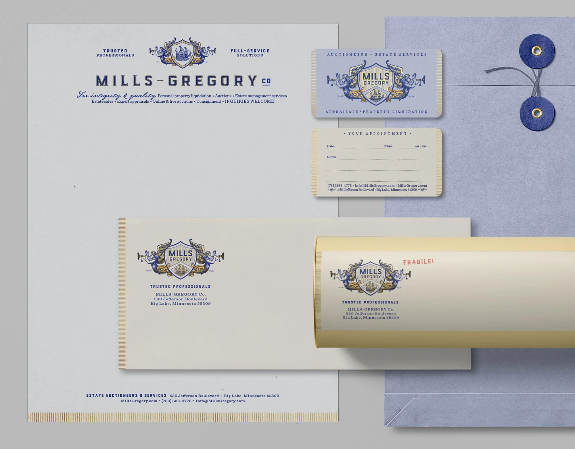 Mills-Gregory stationery system with gold and blue graphics printed on toothy cream and white papers.