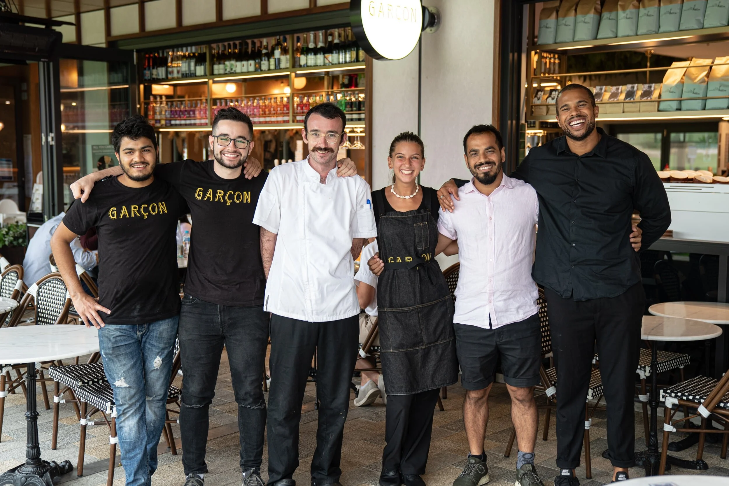 Team photo in front of the Garcon Cafe &amp; Bar Tramsheds