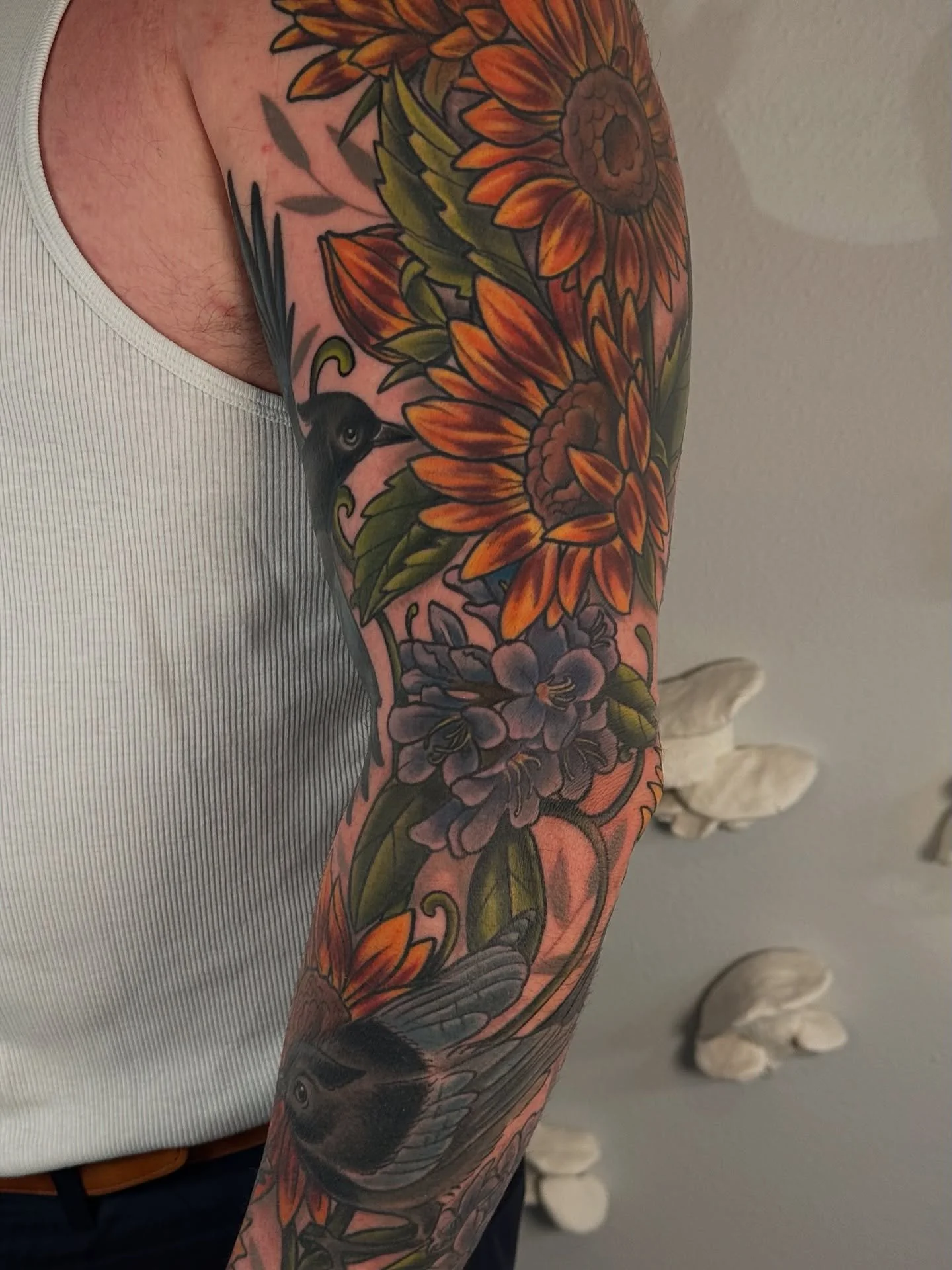 Bryan&rsquo;s first of two sleeves, all healed up! We started with the sunflowers on his upper arm before he wanted to expand it into a sleeve. He was inspired by epic battles between robins and jays in his yard.

I learned a lot during this process,