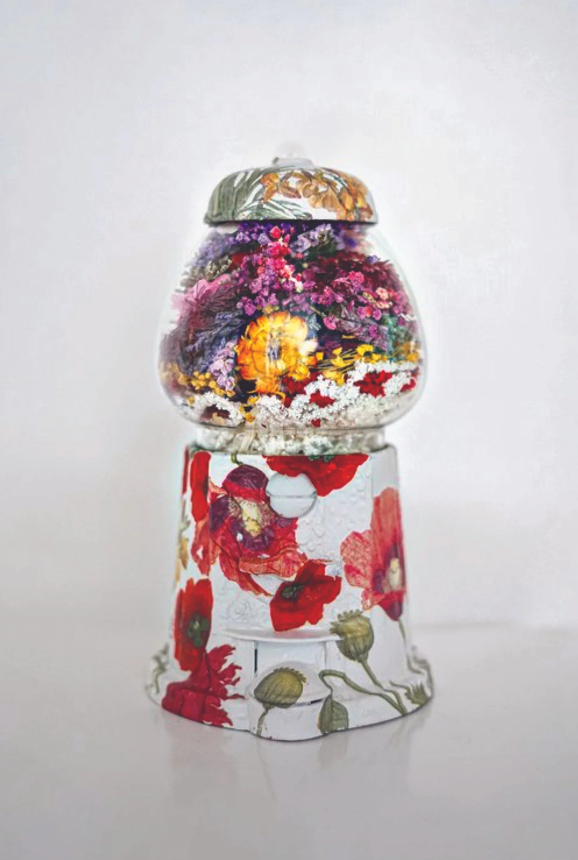 Glass snow globe with a floral scene inside and floral designs on the base.