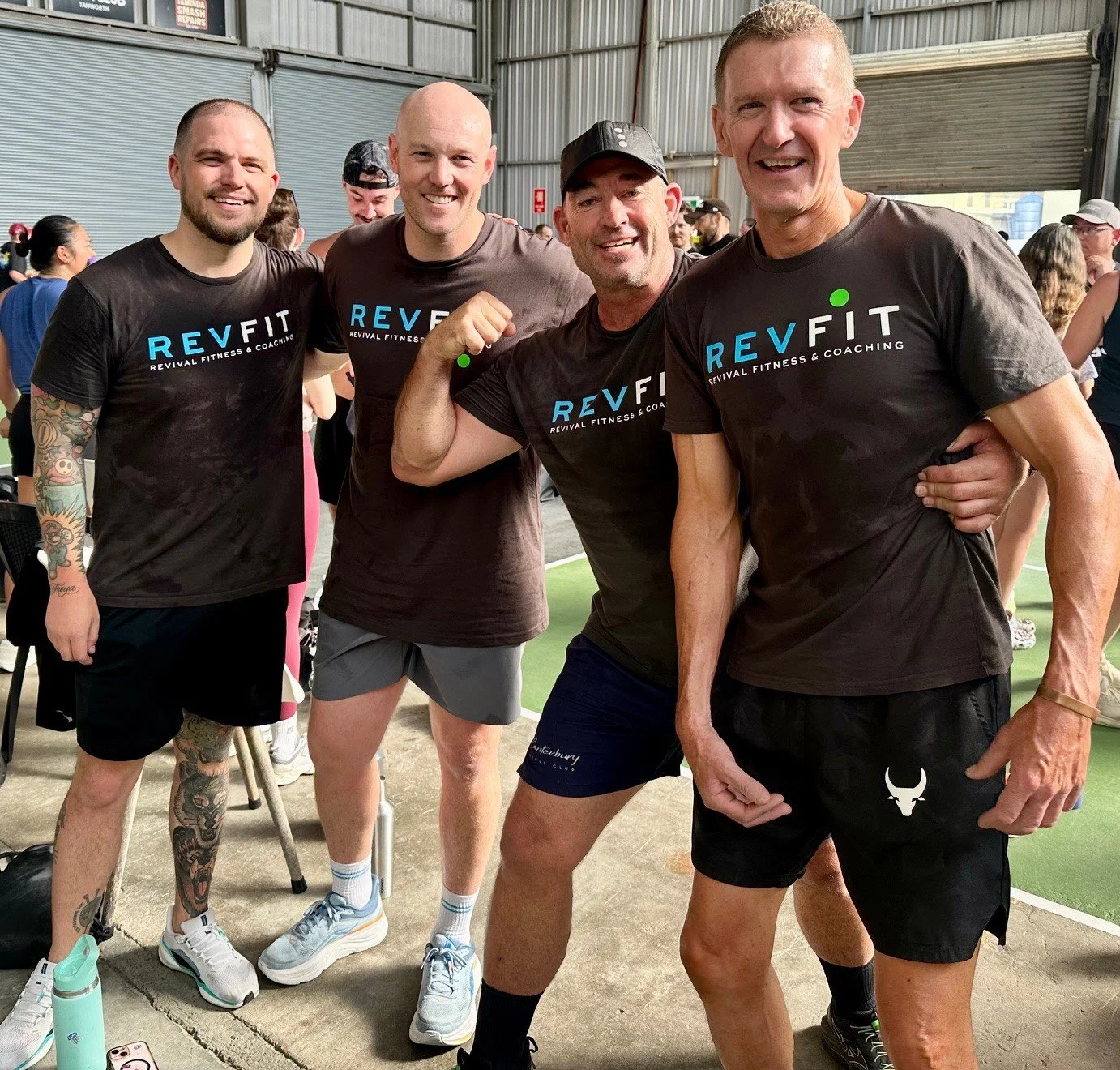 Friendly personal trainers smiling in matching team shirts at RevFit fitness gym in Taminda Tamworth gym.