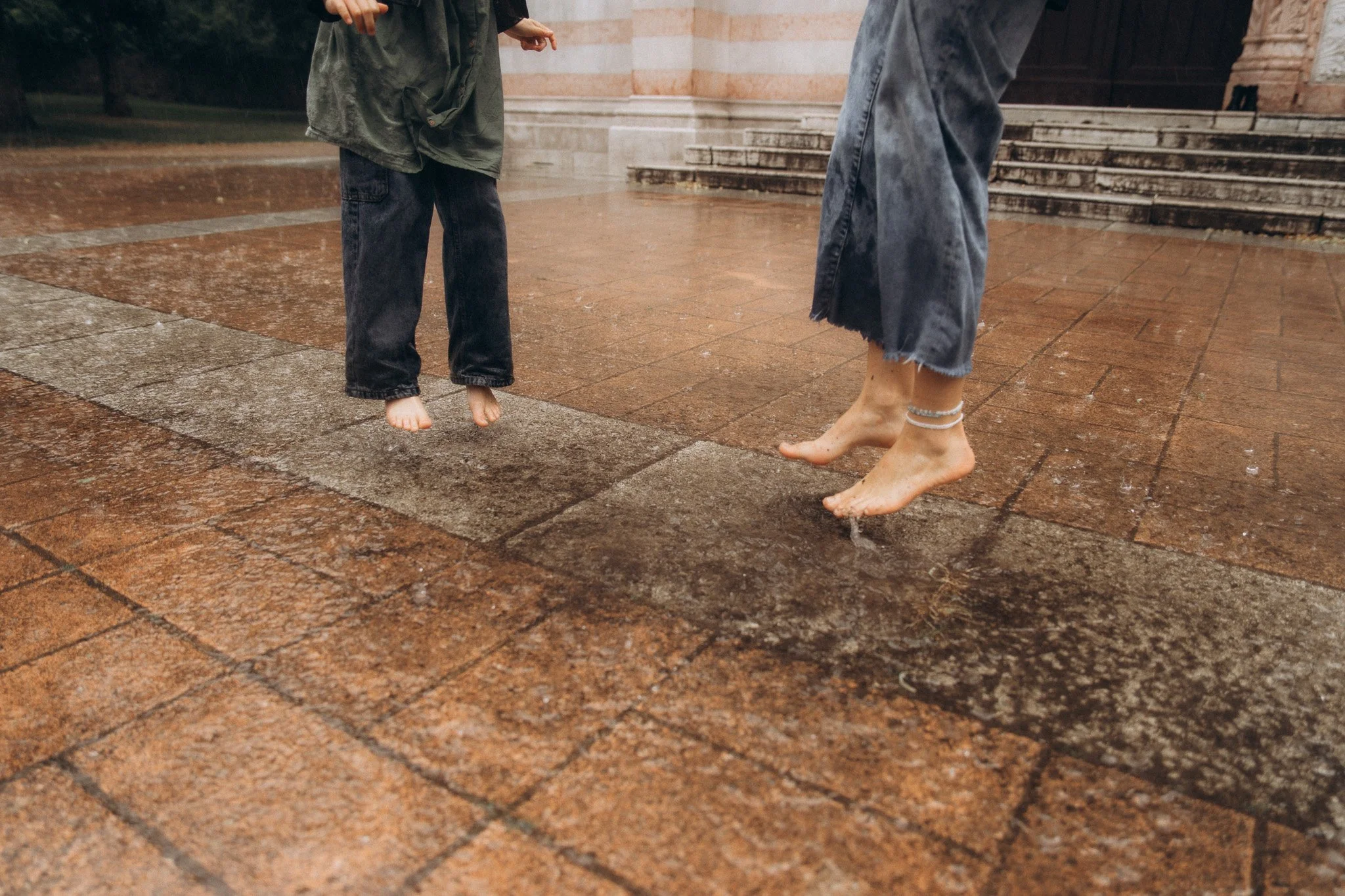 Detail nohou maminky a dcery během deštivého focení