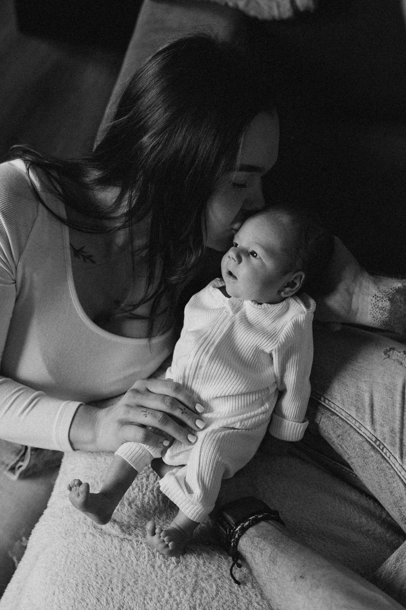 Maminka hladí miminko během domácího focení