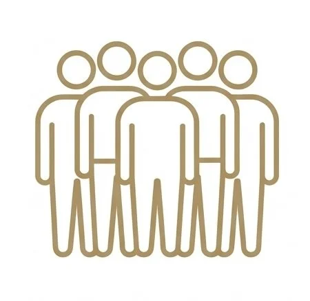 Two people sitting on a floral patterned sofa, having a discussion in a minimalist room with a large white wall, a wooden side table, and a floor lamp.