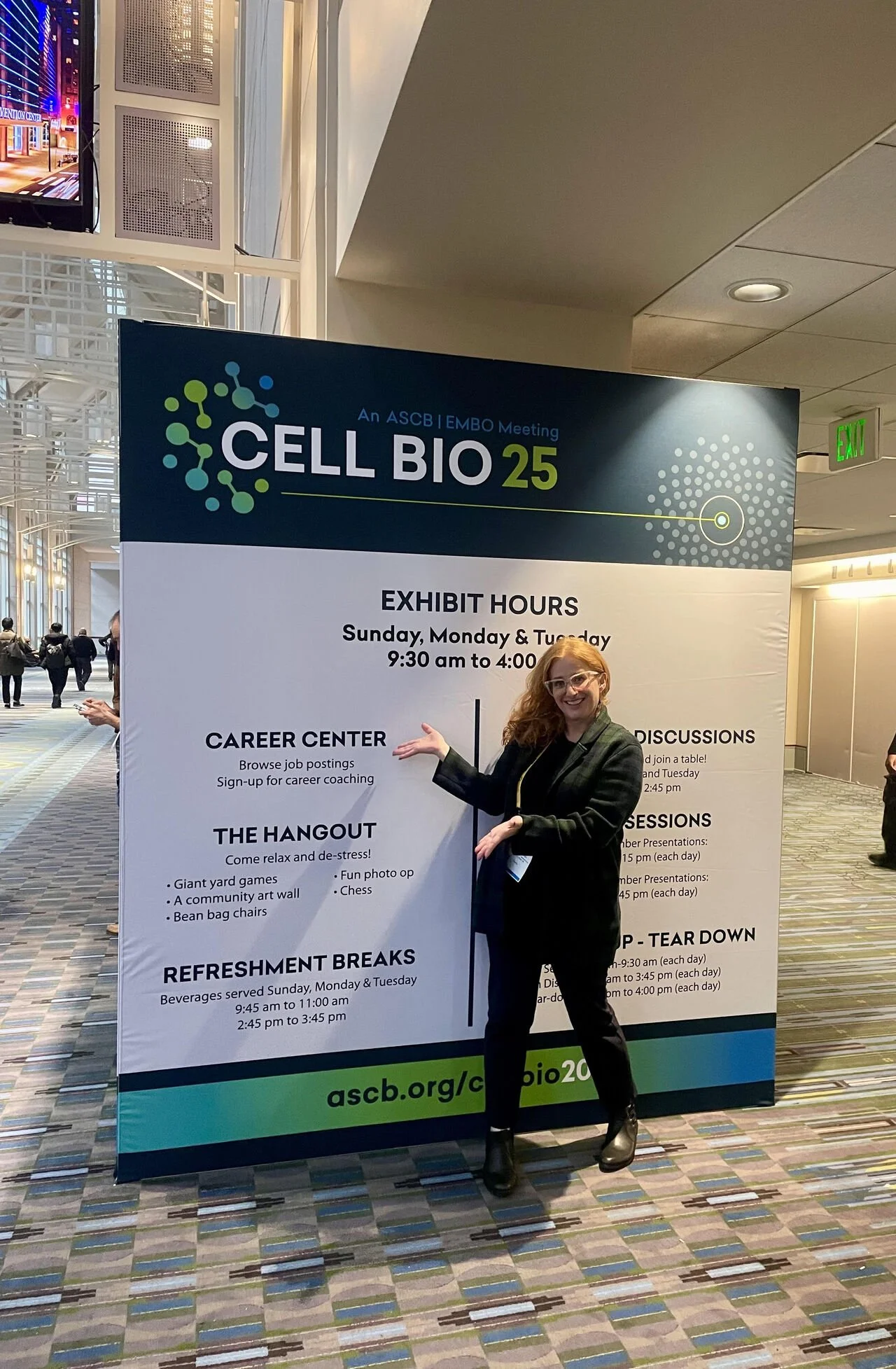 Career expert Rita Friedman stands in front of signage at the ASCB Convention