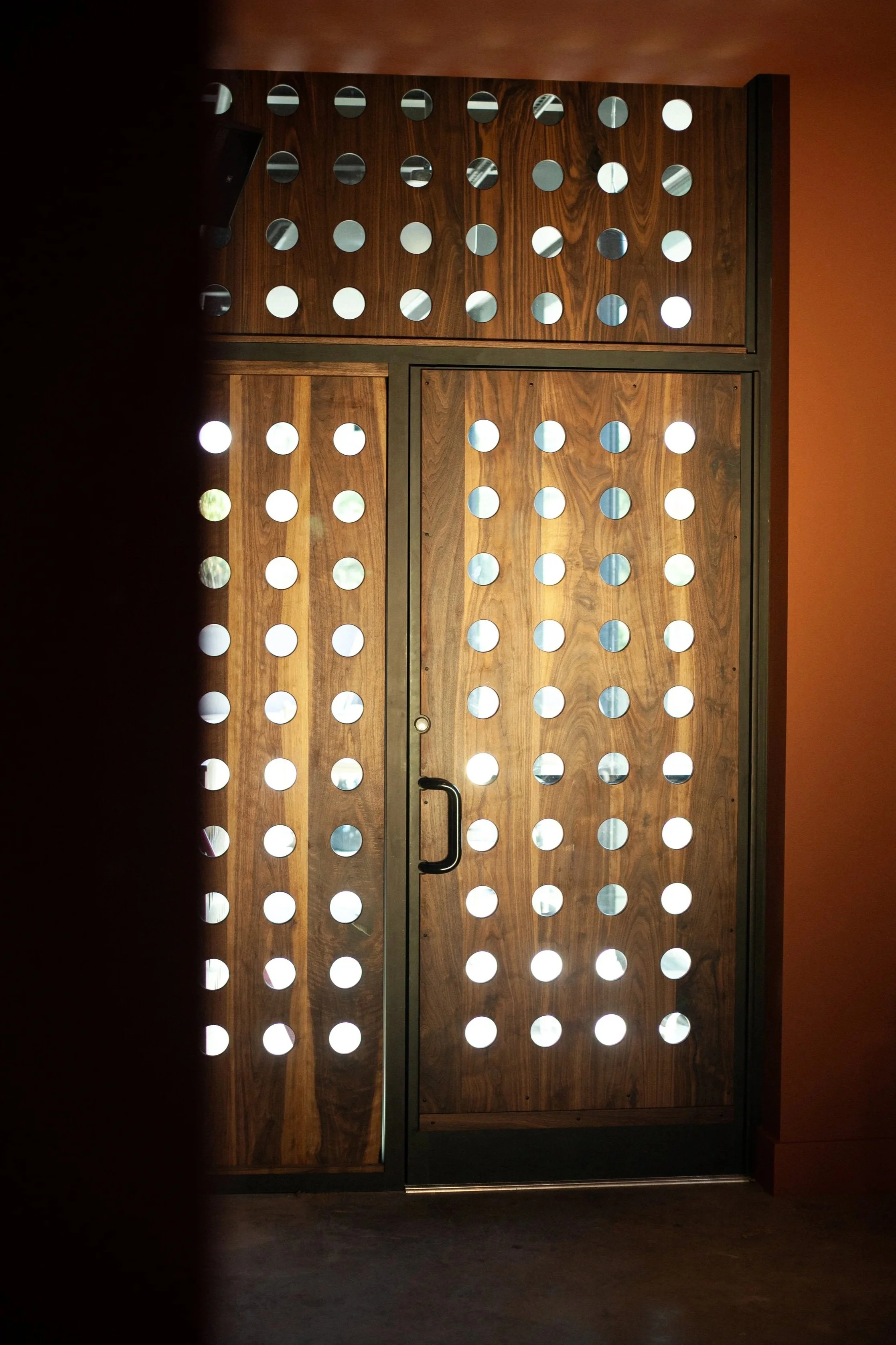 walnut door with inset panels for a commercial rooftop space