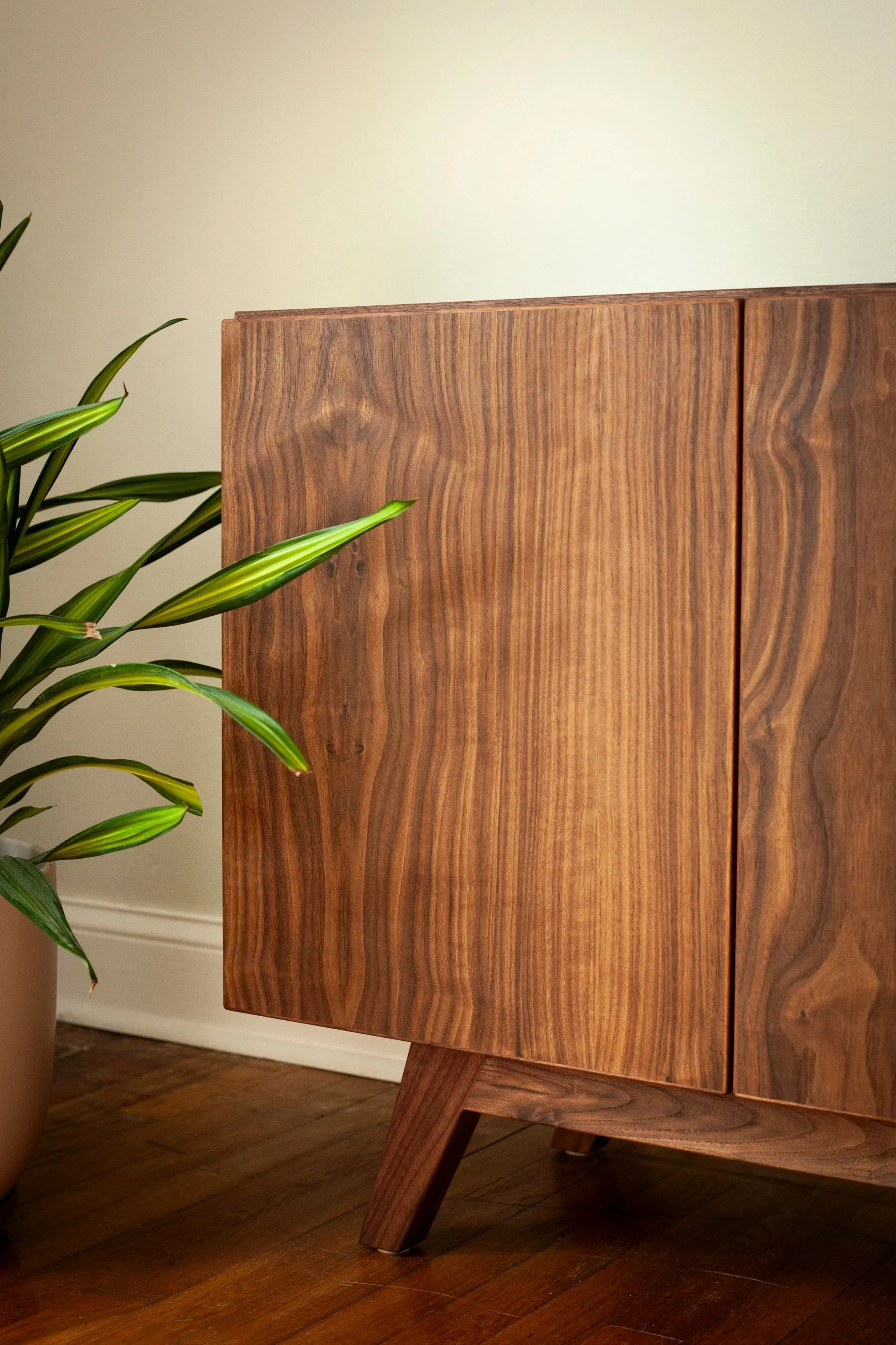 Scandinavian style walnut media console with minimal hardware
