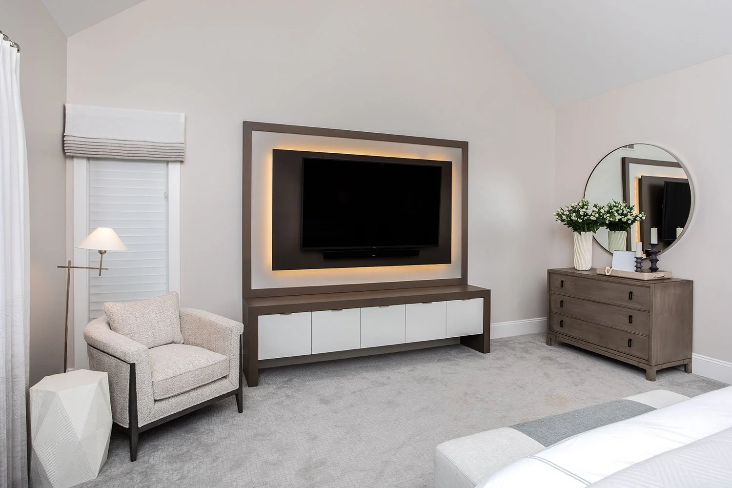 Cleveland Ohio master bedroom with custom entertainment center backlit television Ambella Chalice armchair