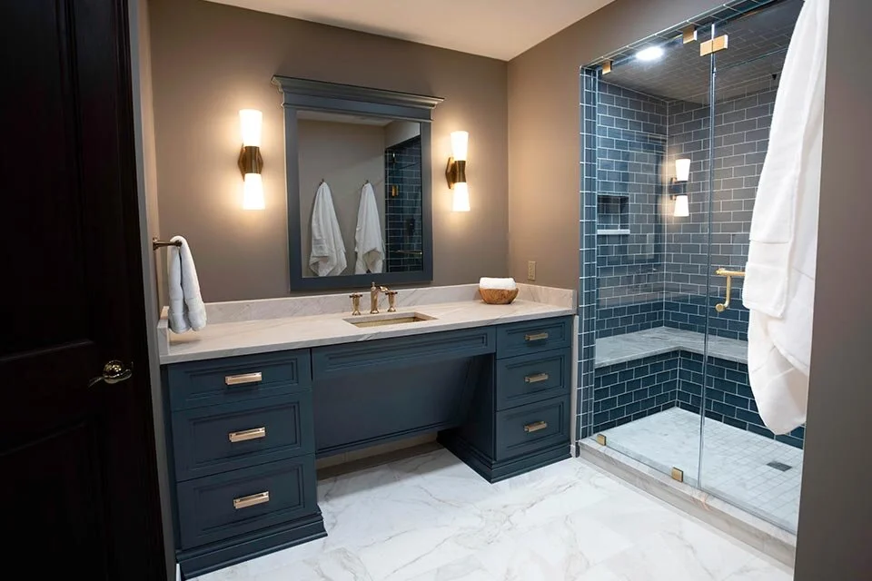 Bathroom with flat panel vanity in executive office with gold accents and shower with Jeffery Court reef glass tile in Oceana Cleveland Ohio