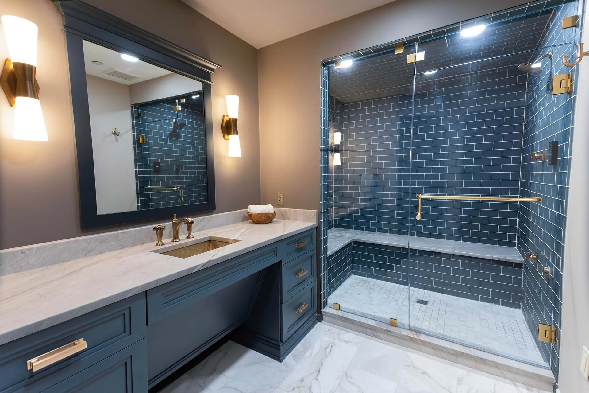 Bathroom with vanity painted SW7625 leathered quartzite countertops custom mirror with crown painted to match cabinet steam shower with multiple shower heads Cleveland Ohio