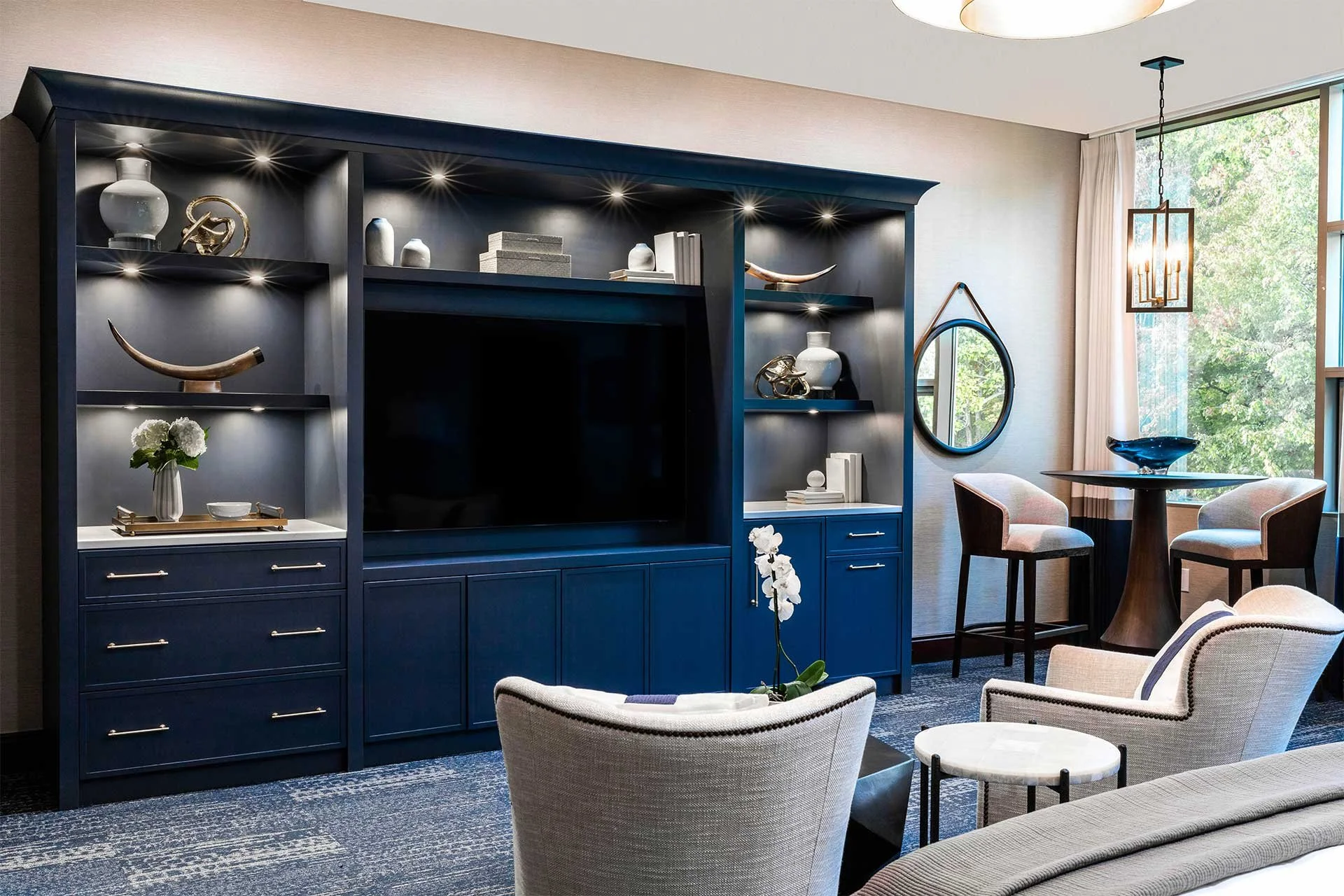 Executive office custom built-in with touch latch cabinetry painted blue Benjamin Moore Hale Navy with seating area with Hinkley Anders Small Single Tier Pendant Cleveland Ohio
