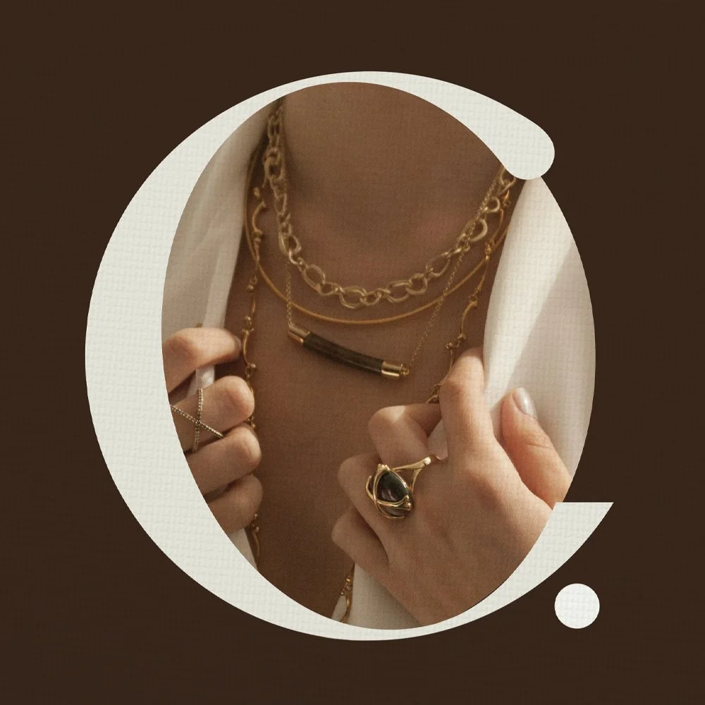 Minimal jewelry and styling detail reflecting a refined visual identity for a boutique brand
