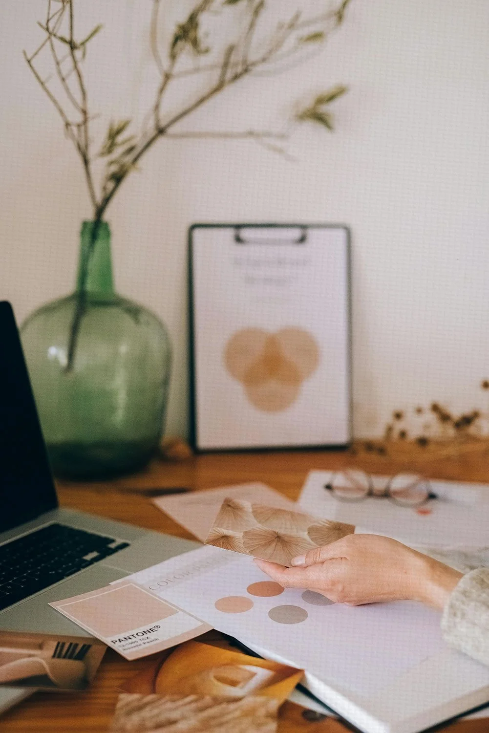 Brand design process at Mariposa Creative, showing visual identity materials and workspace