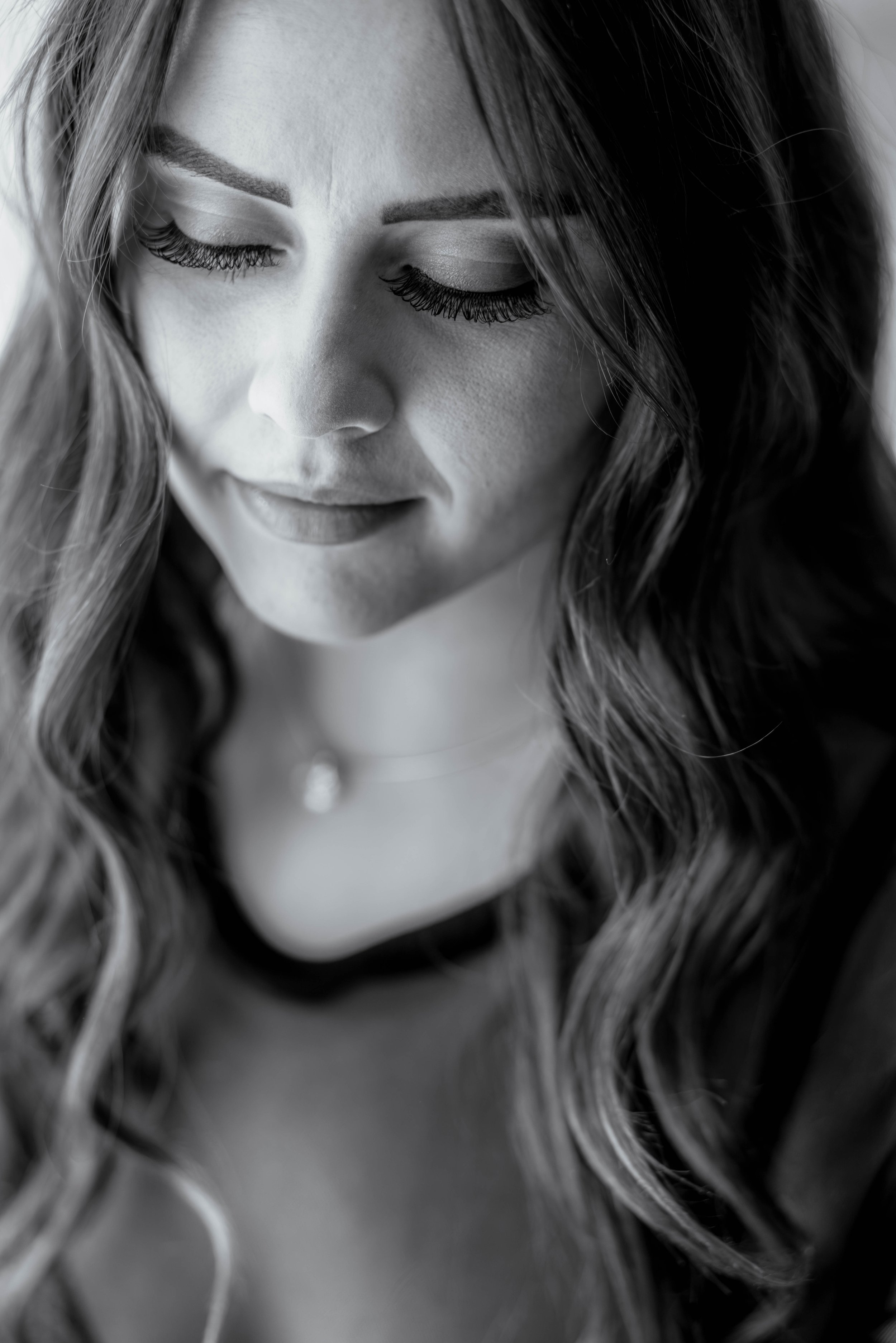 A close-up image of this dark haired beauty with the on-point eyelashes shows the importance of allowing yourself to be uniquely your for your boudoir images.