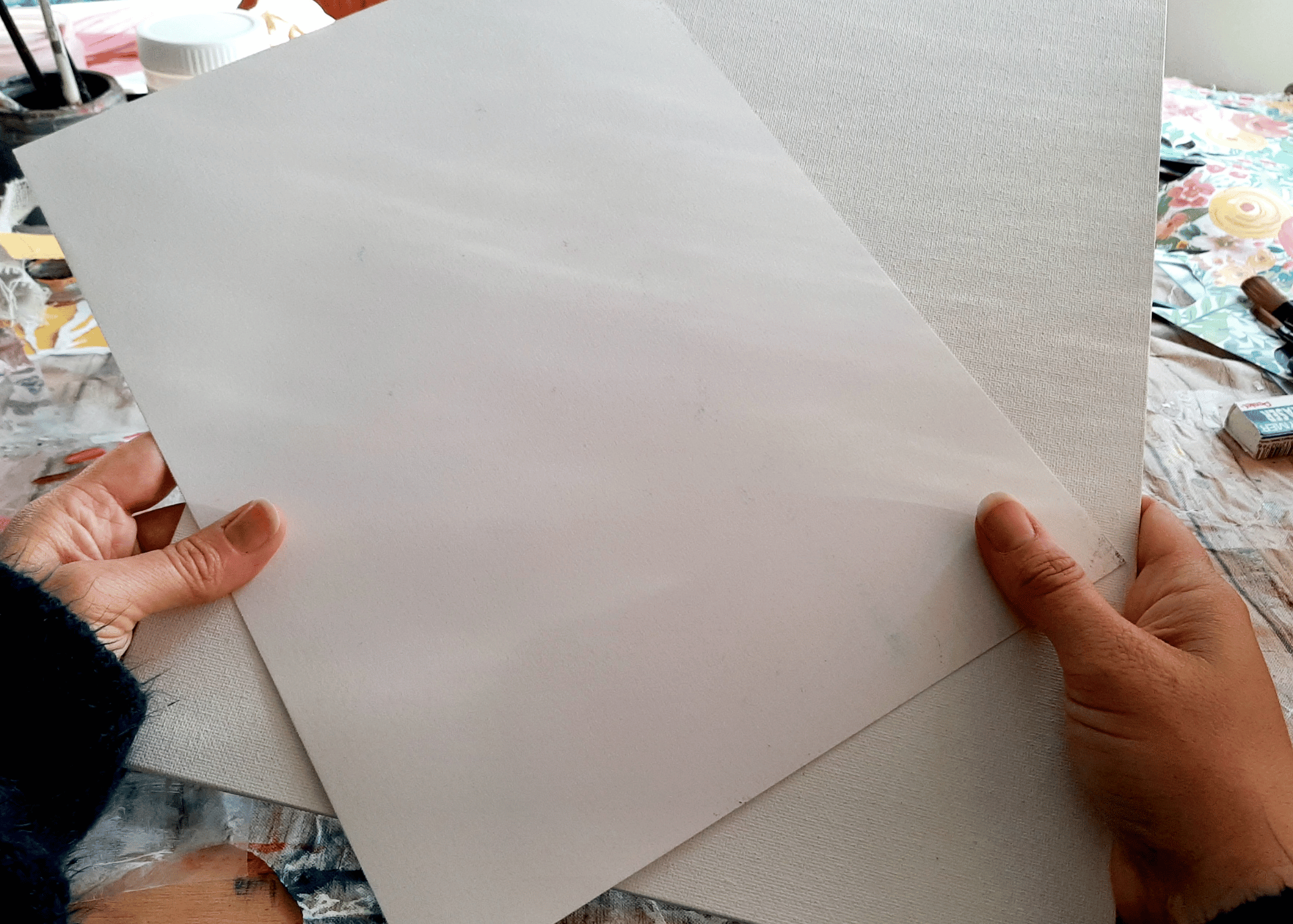 canvas-and-mixed-media-paper-in-Misty's-hands.png