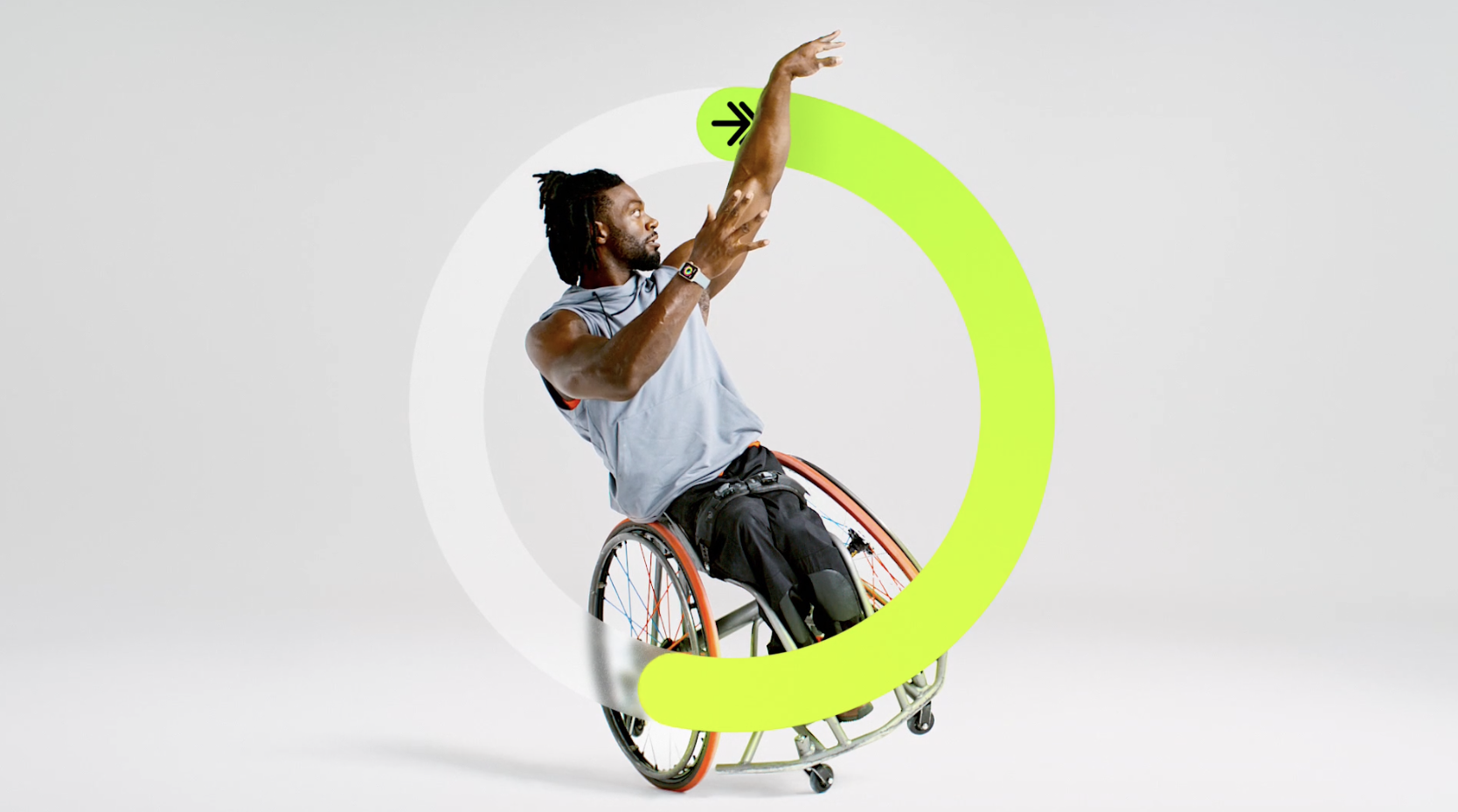 a man in a wheelchair exercises with a green ring closing around him. the image is from an Apple Watch commercial