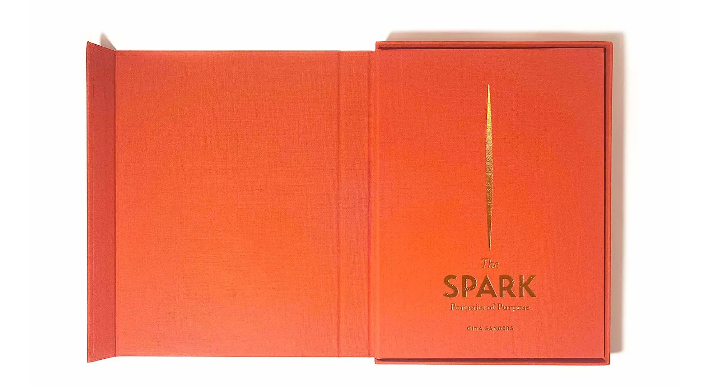 an orange book titled "The Spark: Portraits of Purpose," a book Jezz Chung wrote in collaboration with Gina Sanders