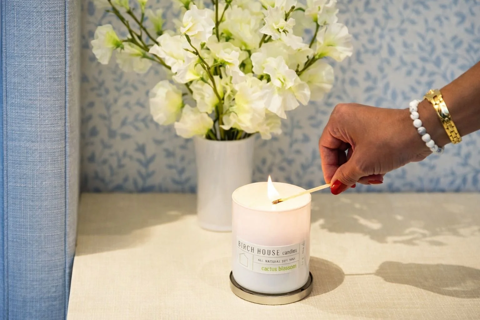 heart sweater holding sweet grapefruit soy candle