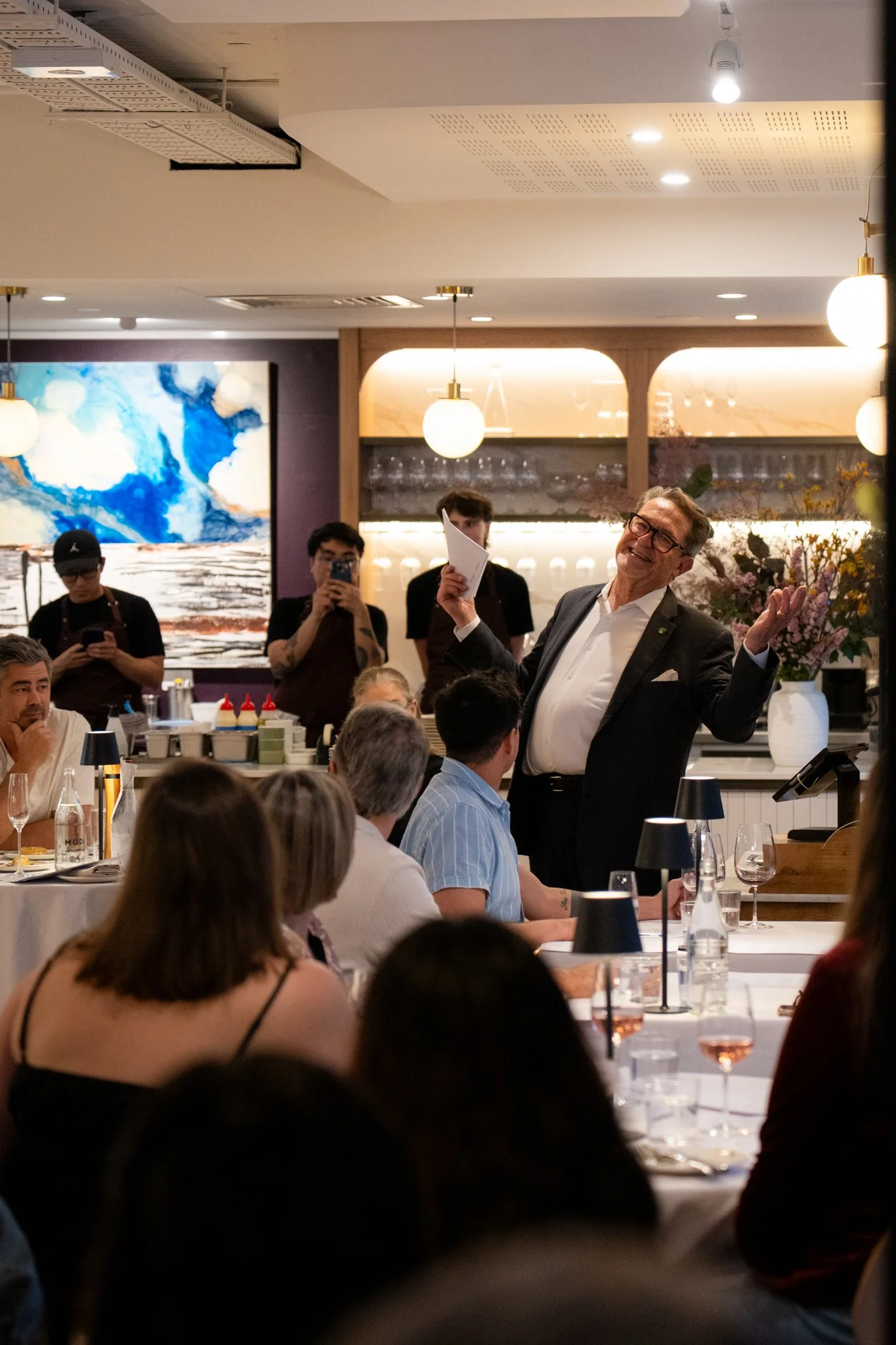 Restaurant host addressing guests during an evening dining experience at Annata Restaurant