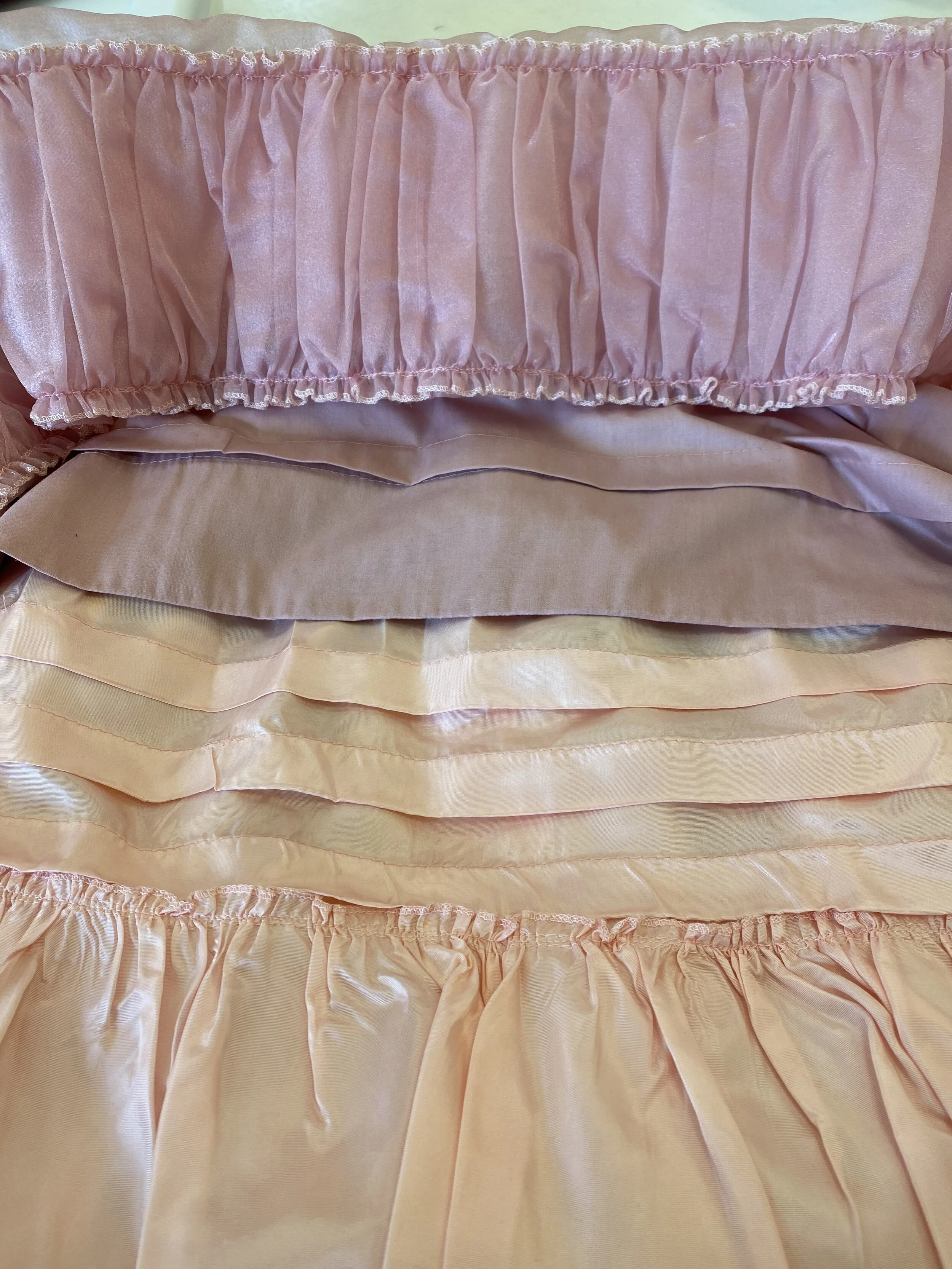 Took tucks, hemmed the outer skirt, removed and reattached the ruffle to accommodate new length.
