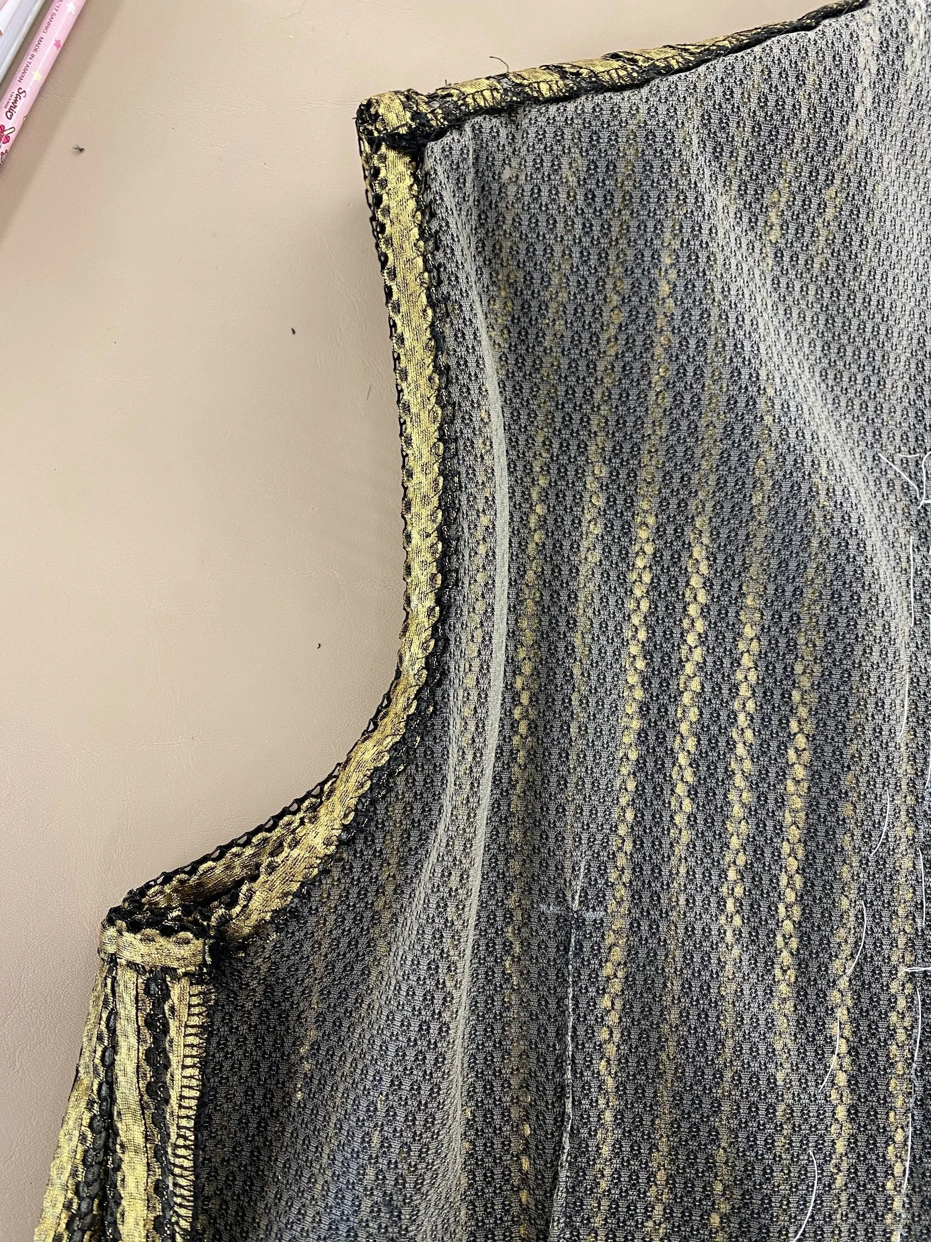 Self bound armhole, finished with a whip stitch. Shoulder seam allowance cross stitched down.