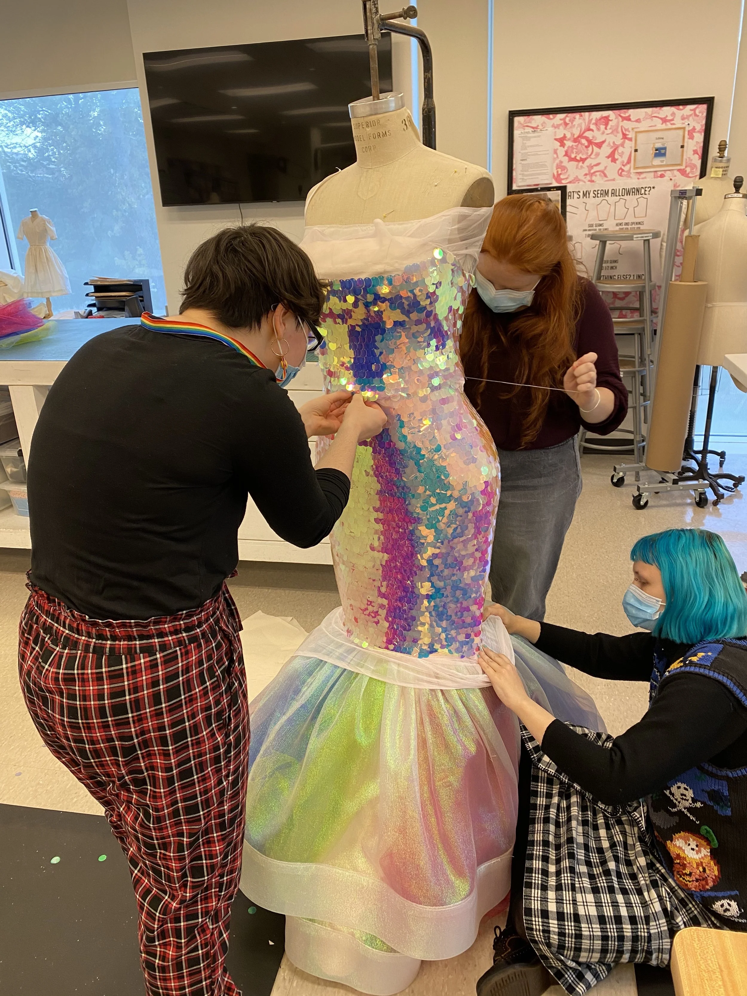 Attaching the piette layer to the dress with my team.