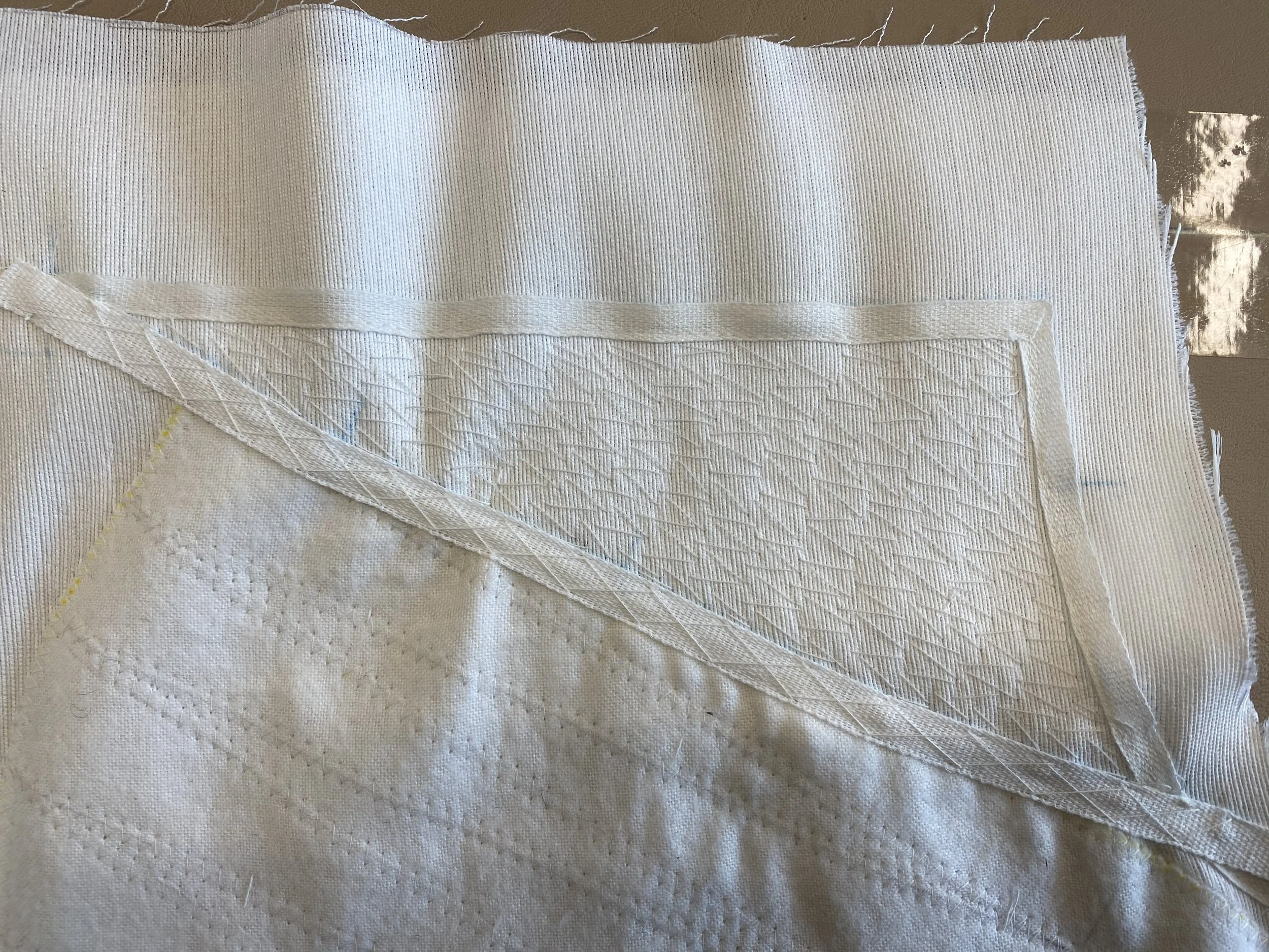 Double cross stitched twill tape on lapel roll line. 