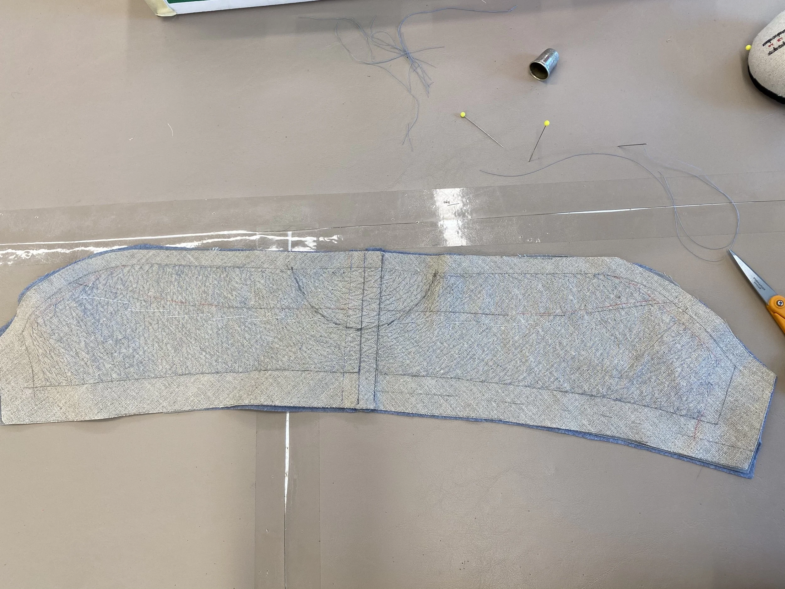 Pad stitching on collar of Onegin's jacket.
