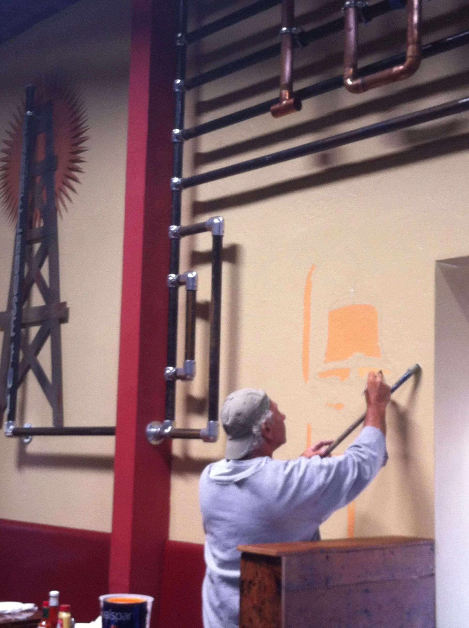 I sourced a local artist that lived on a boat. Here he is painting the California Mission Bell. 