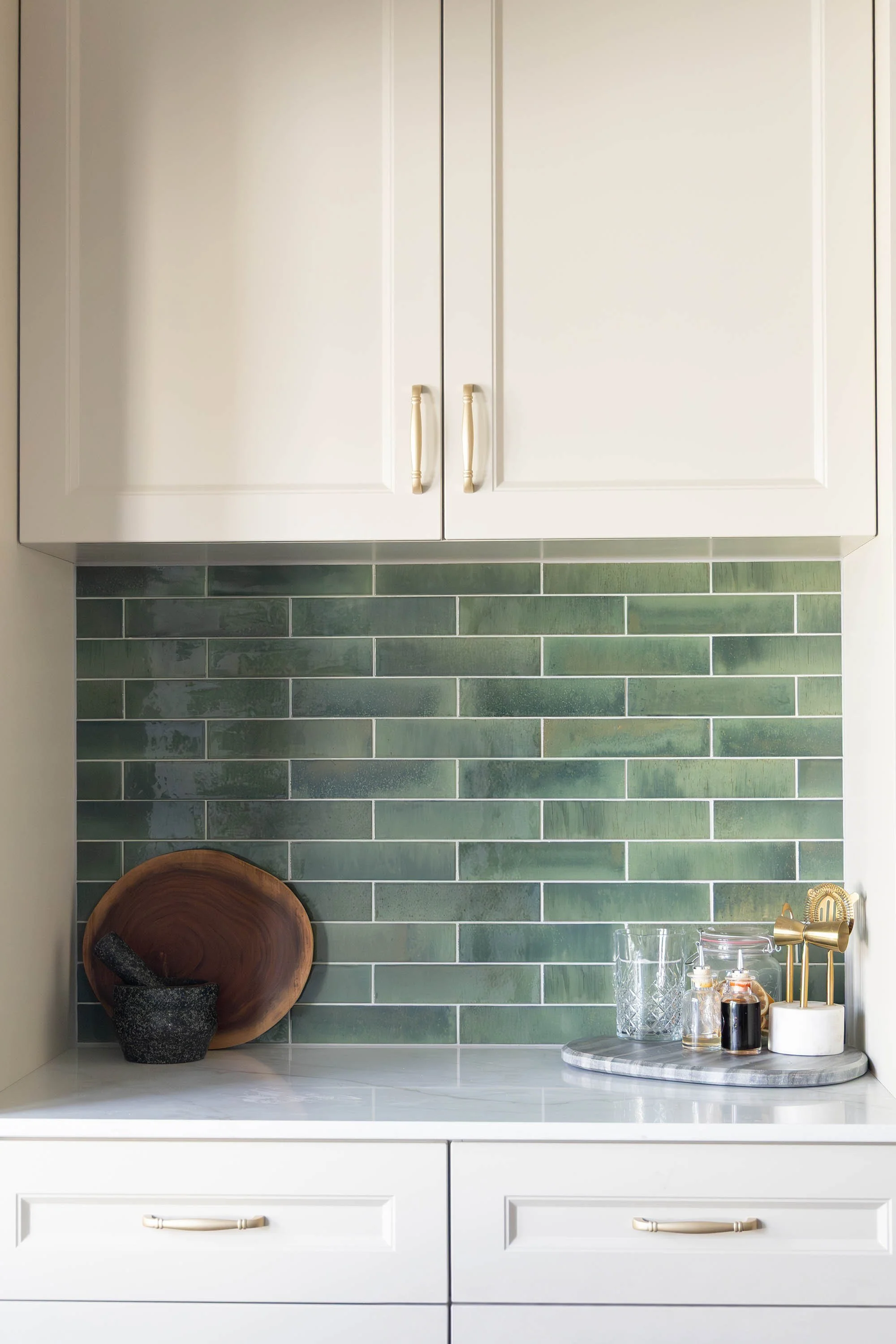 Green kitchen splashback tile with white cabinetry