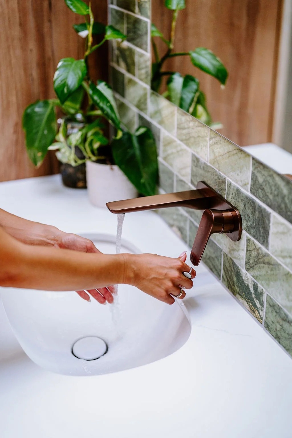 Green bathroom feature tile with copper/ bronze fittings and fixtures