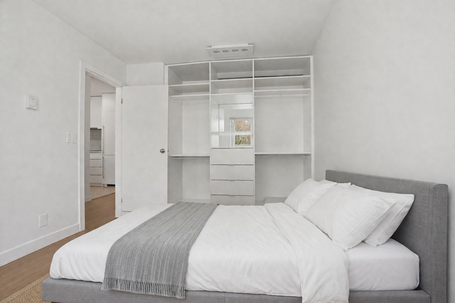 Minimalist bedroom with open wardrobe design.png