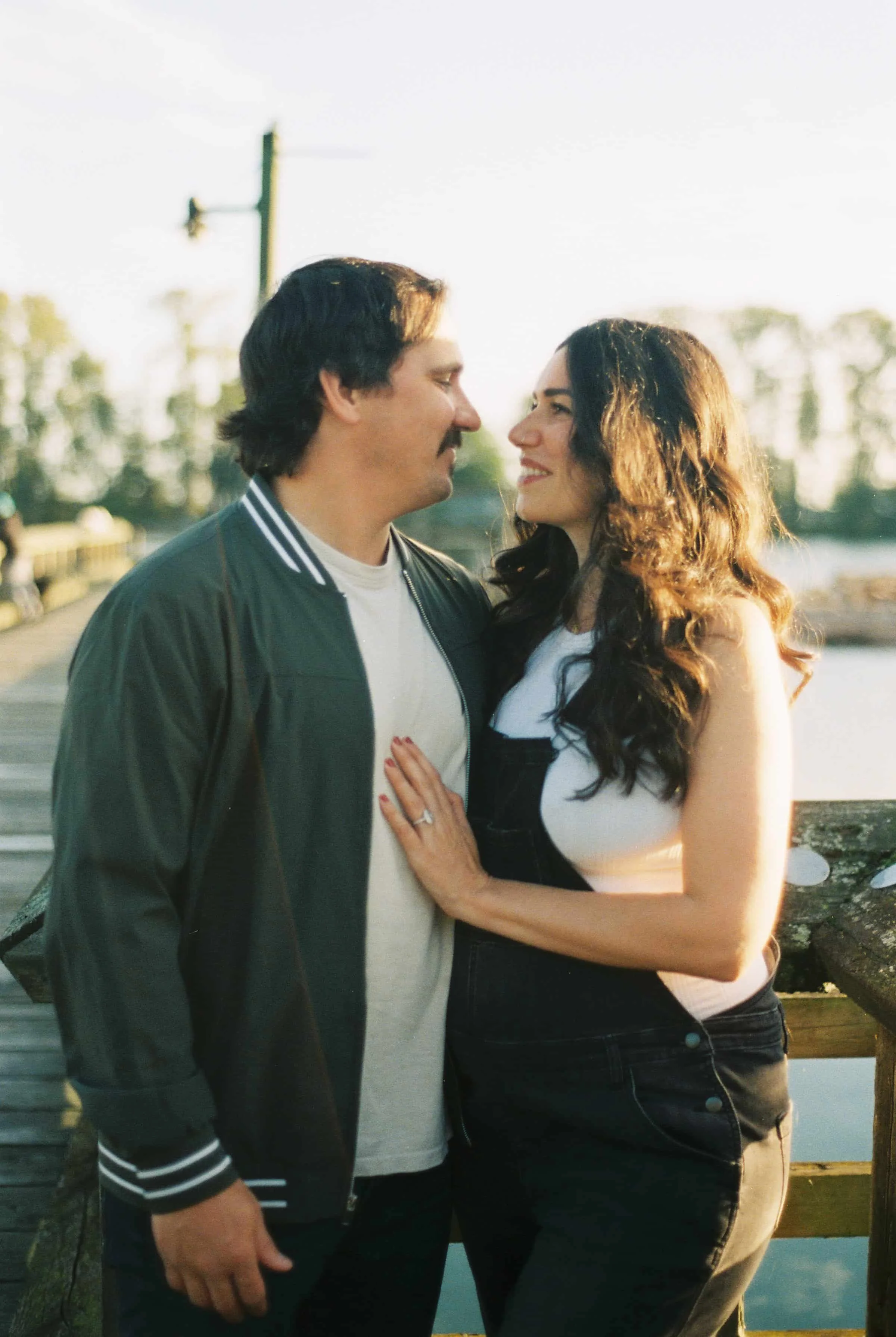 maternity golden hour overalls beach waves husband his and hers