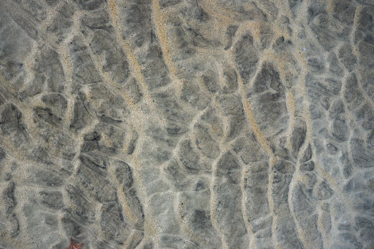 Abstract architectural photograph of converging structural lines, evoking alignment and connection between separate parts.