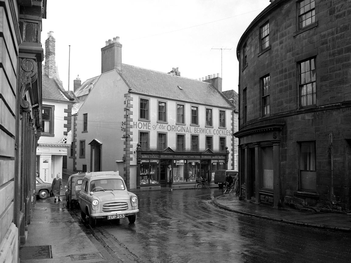 William Cowe and Sons the ‘Home of the Original Berwick Cockles’. ‘Cockles’, a local peppermint sweet, had been made here since 1801. The scene remains practically unchanged today.
(March 1958) BRO-1-1944-1872-11