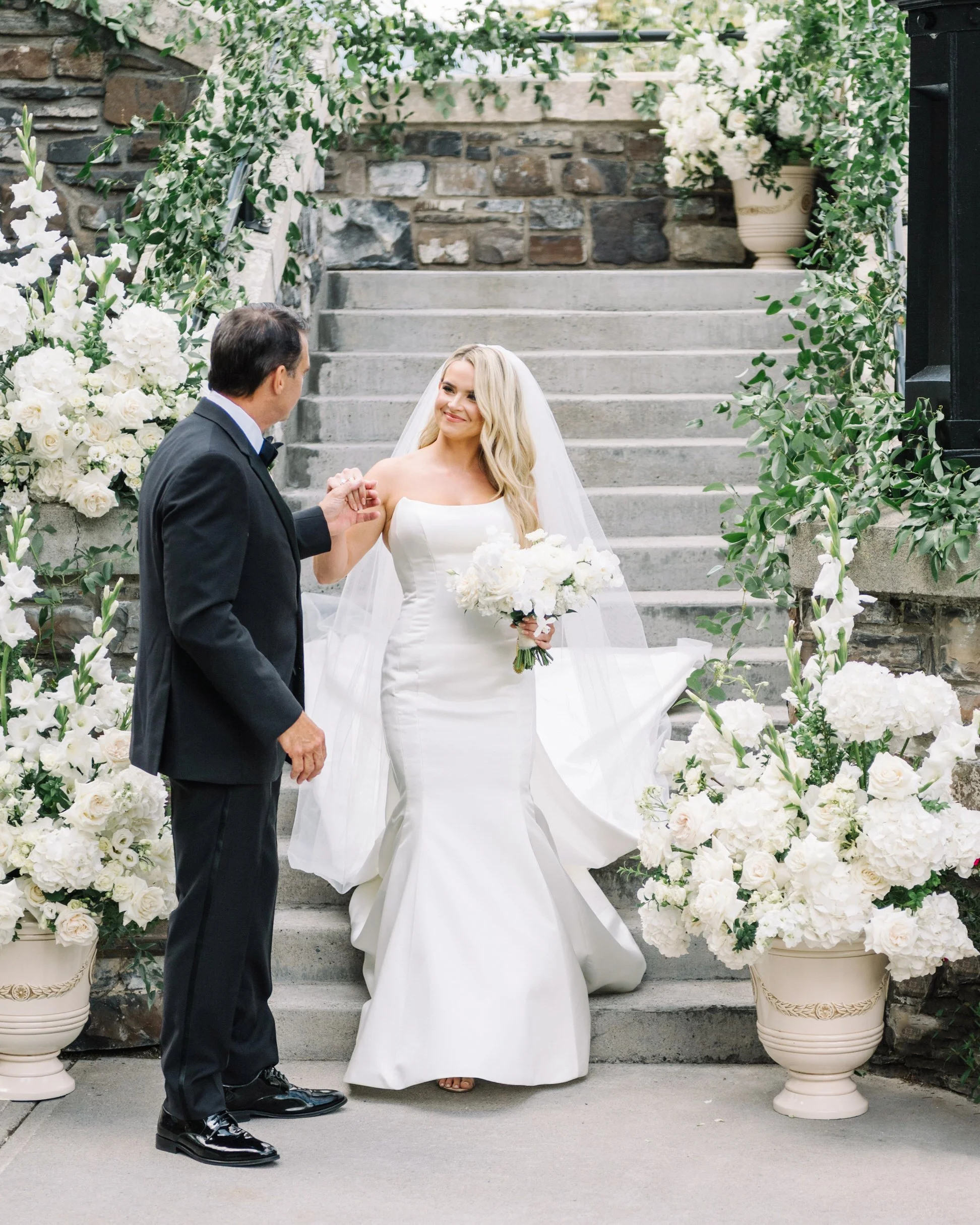 Bride walking down the stairs to dad at the Fairmont Banff Springs
