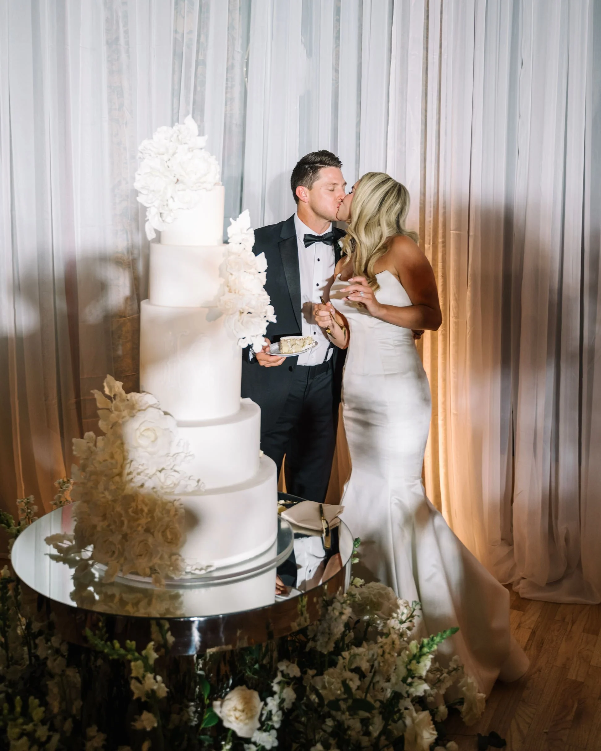 Bride and groom with 5-tier wedding cake 