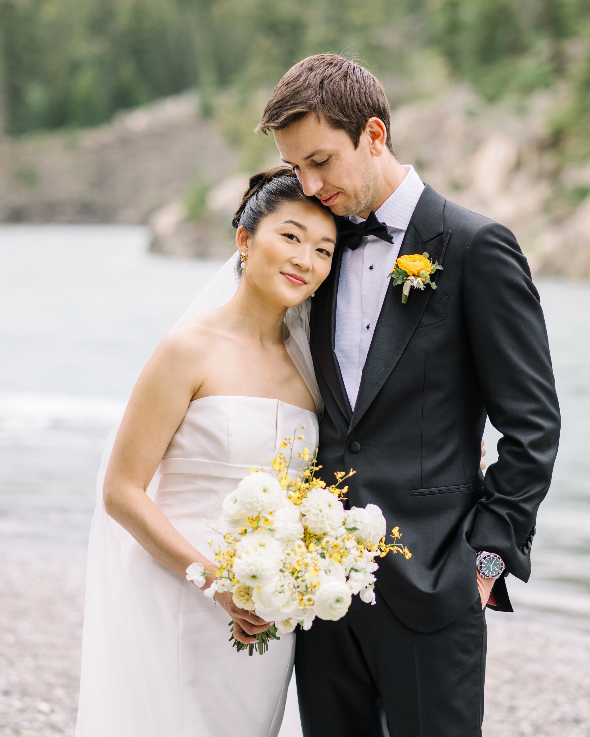 Bride and groom portraits at Bow Falls in Banff