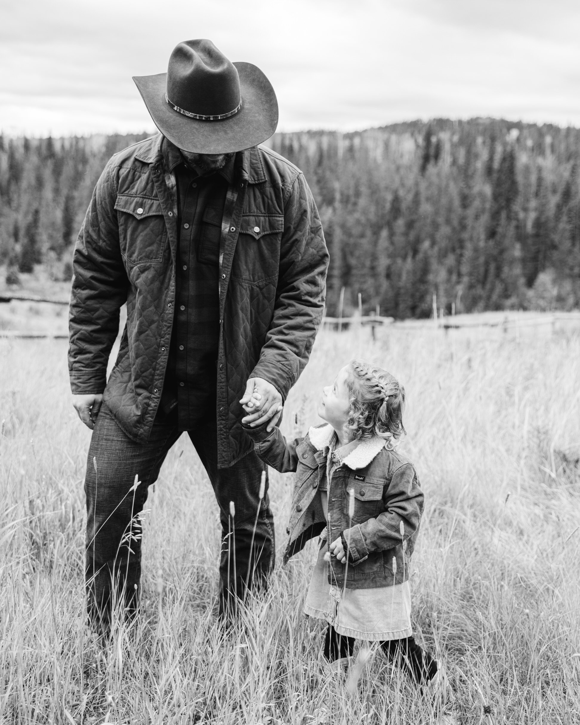 Cowboy holding girls had at the family Ranch