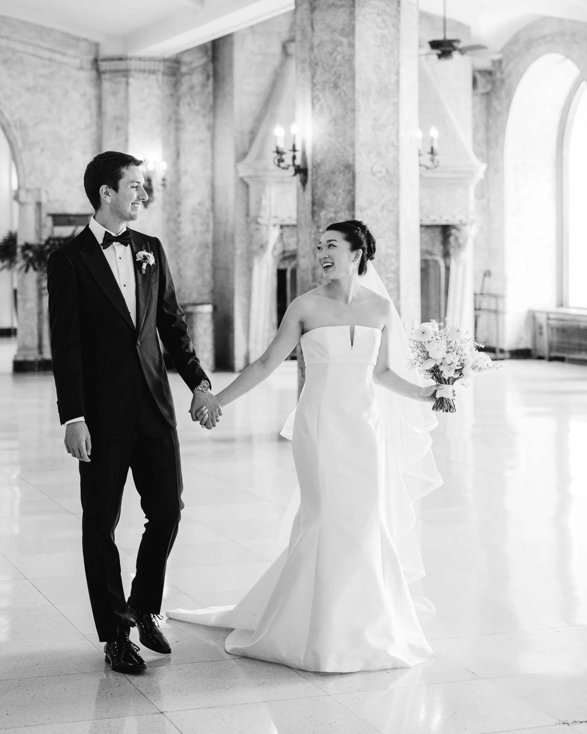 Bride and groom walking inside the Fairmont Banff Springs