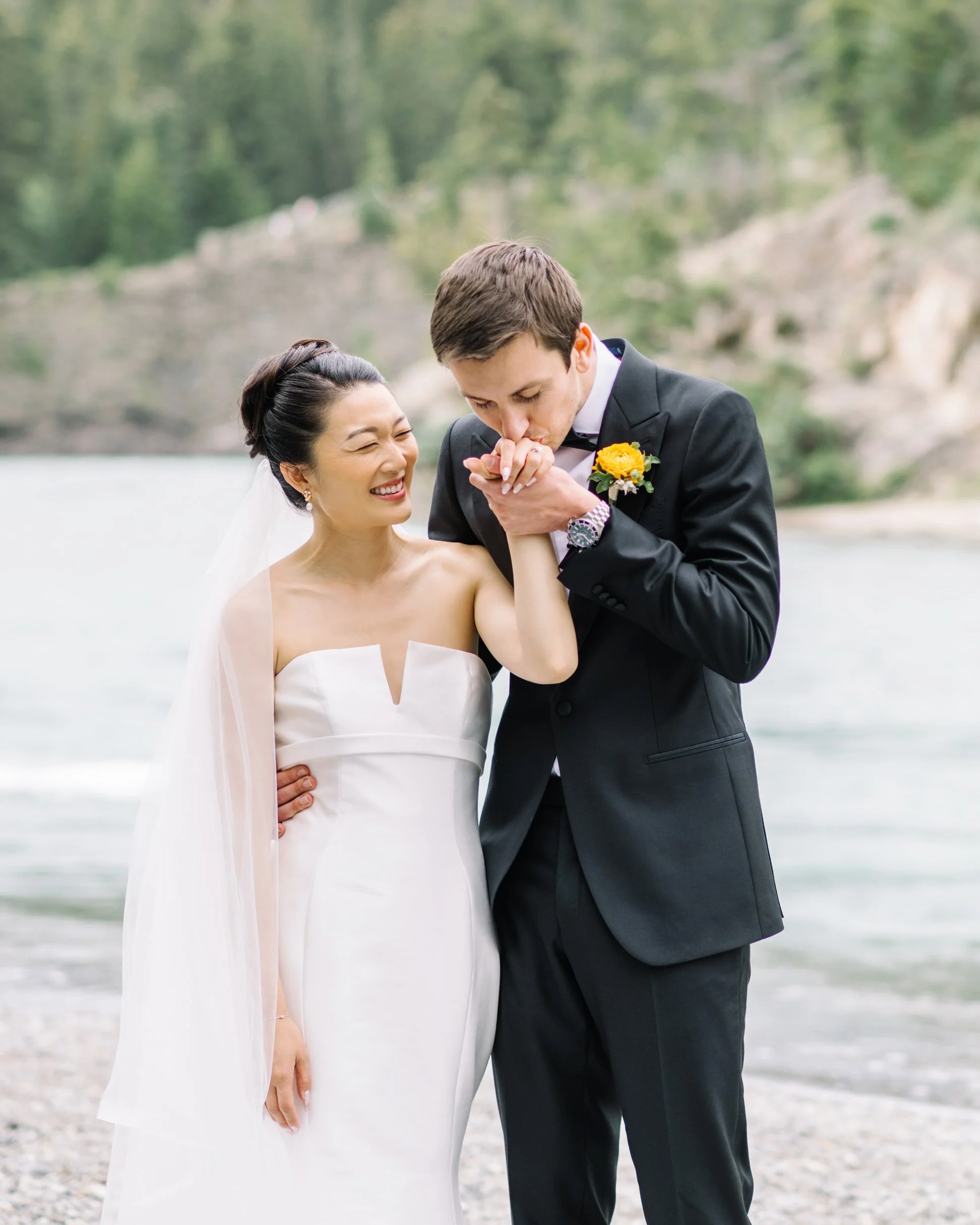 Bride and groom portraits at Bow Falls in Banff