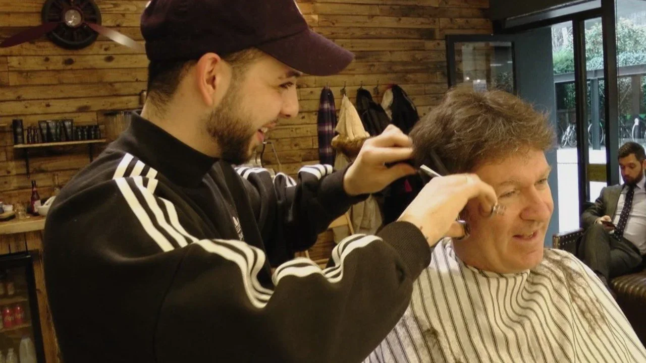 Man at barbershop in London