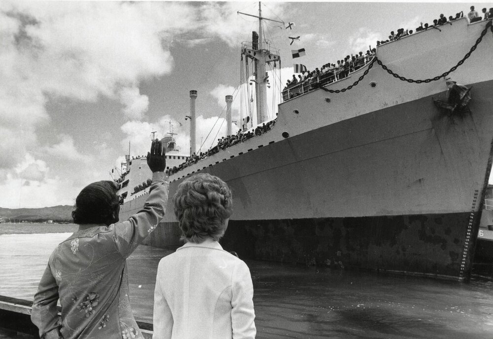 Gov. Ricky Bordallo and Madeleine Bordallo wave to a ship of repatriates, departing from Guam to Vietnam. 1975