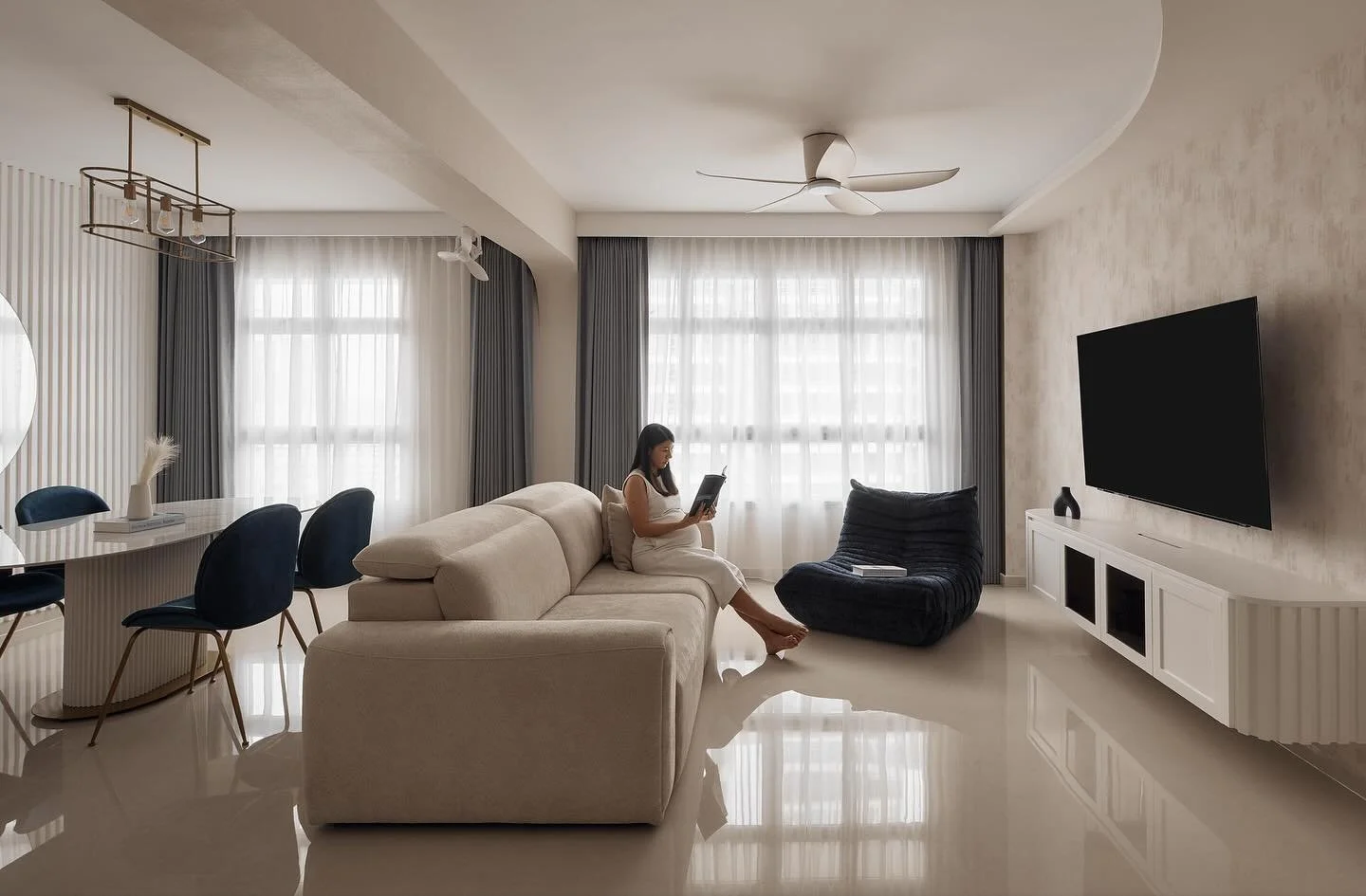 We like that there&rsquo;s strip lighting scattered across this space to illuminate different materials: from the curtains and floor, to the wall paper and brass laminates. 

The hand painted fluted panels at the entrance, on the TV console and at th