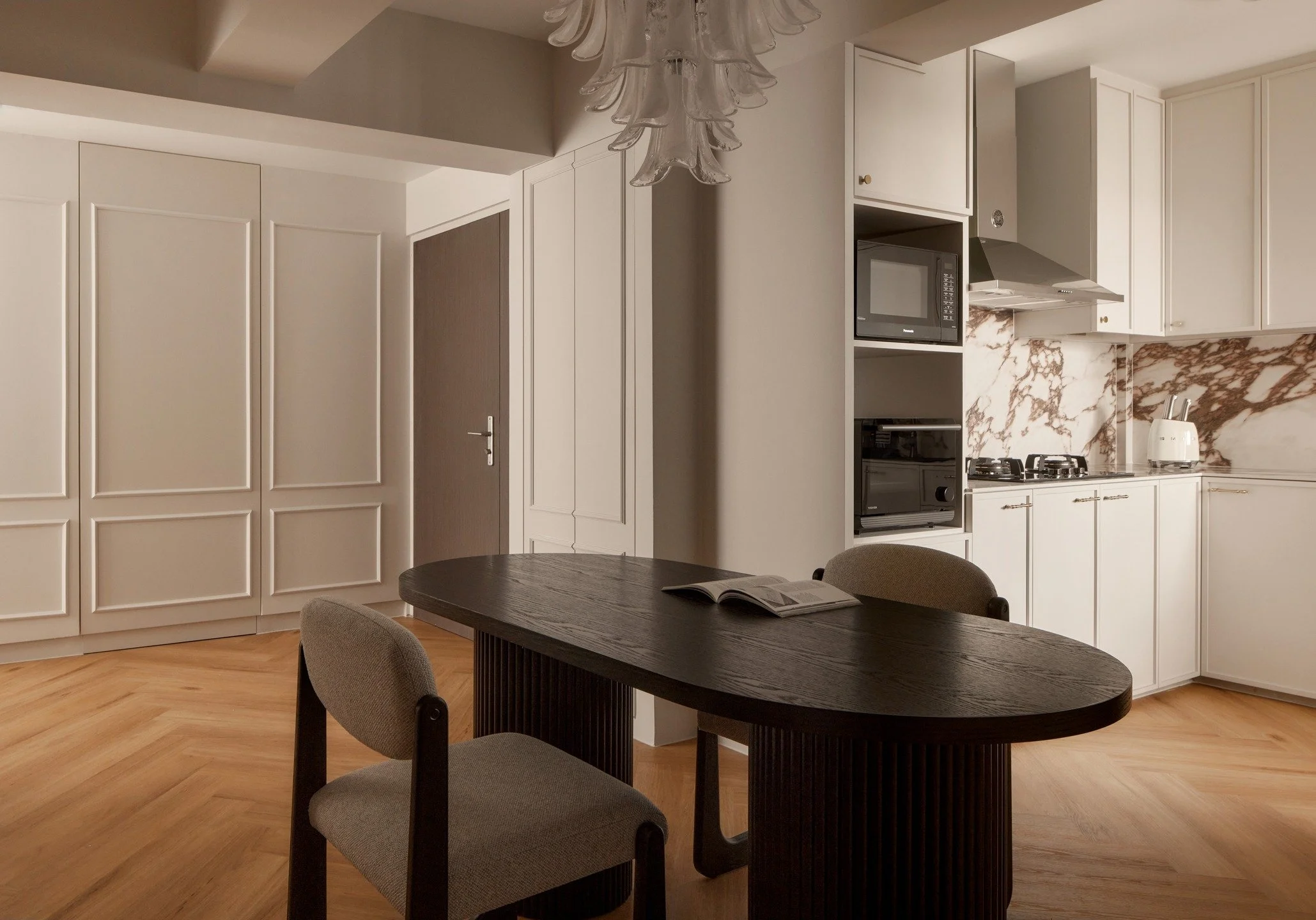 The consistent dimensions of the doors, wall beading, plus having herringbone flooring through out brings a lovely harmony across this house.

The purplish backsplash is a bold choice that paid off. As the saying goes, risk brings rewards. We encoura