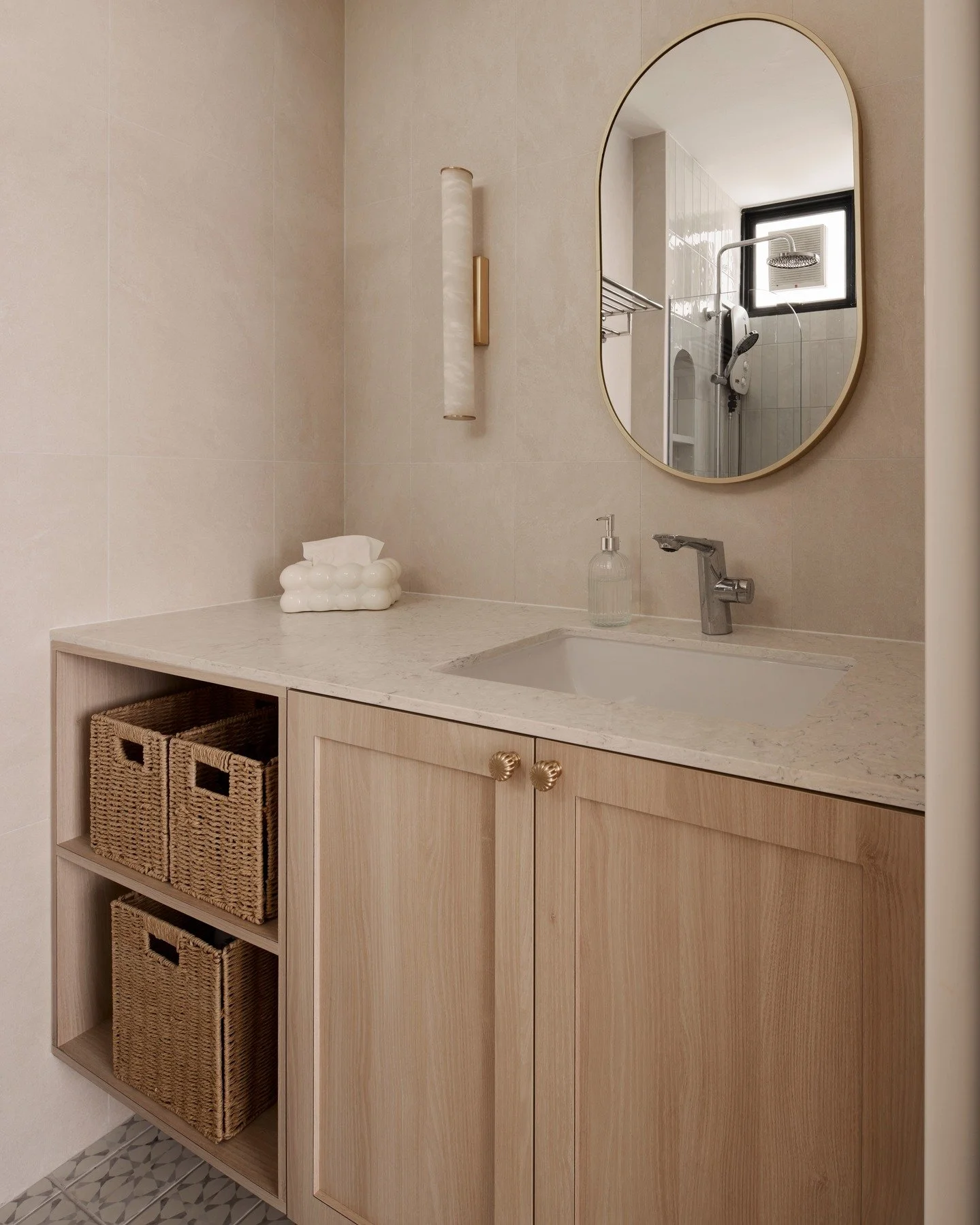 For us, this mix of white quartz, clean wood and wall tiles that have a slightly pinkish hue is so soothing to look at. 

Given that its quite a compact space, we are glad no top cabinets were built. In place instead is this mirror and alabaster wall