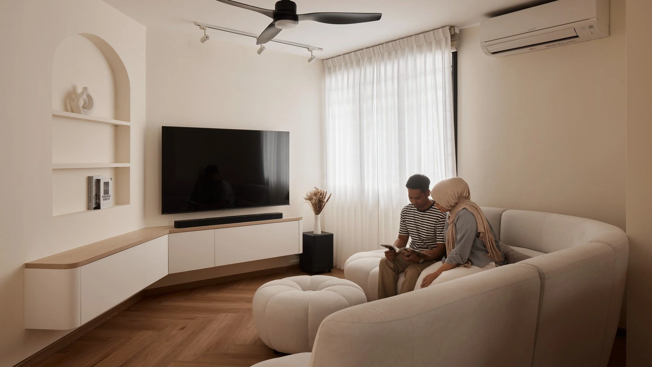 Odd angles in spaces are challenging but also present opportunities to be creative.

Here, the walls are painted in the same light muted colour so angles are less pronounced. 

Curves in the partition wall and console further balances the angled wall